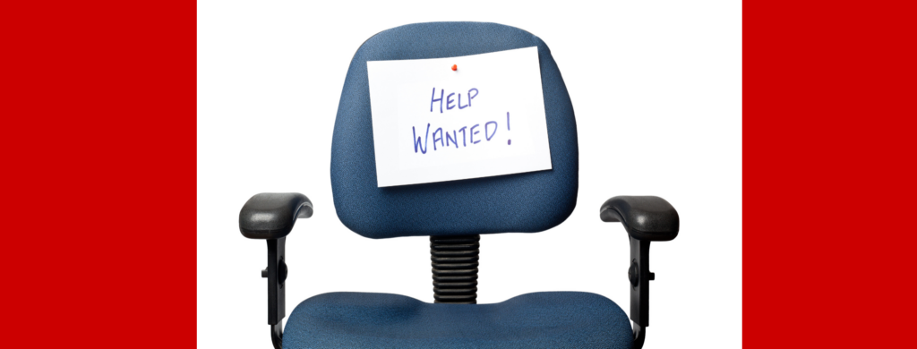 Desk chair with help wanted sign